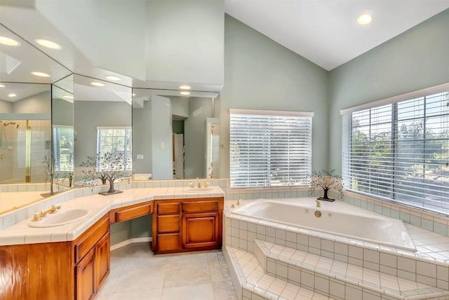 bathroom featuring a bath, recessed lighting, a sink, and tile patterned flooring