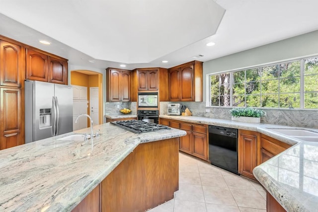 kitchen with a sink, recessed lighting, decorative backsplash, light tile patterned floors, and black appliances