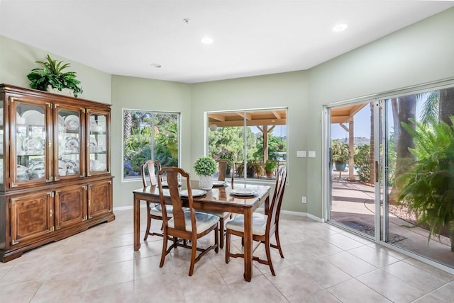 dining space featuring recessed lighting, baseboards, and light tile patterned floors