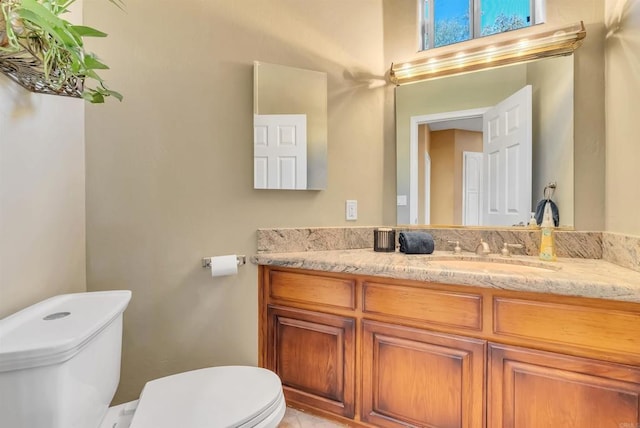 half bathroom with toilet and vanity