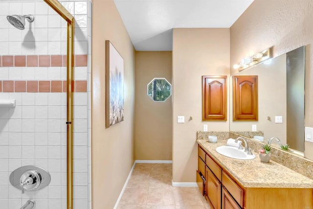 full bathroom featuring tile patterned floors, baseboards, vanity, and tiled shower