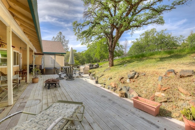 wooden deck featuring an outdoor fire pit