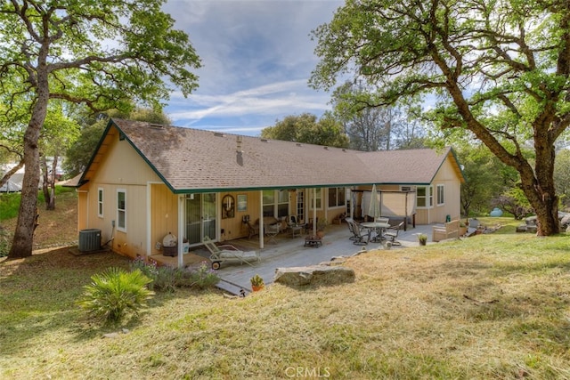 back of house featuring a patio area, central AC, and a yard