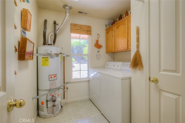 laundry room with independent washer and dryer, cabinets, light tile patterned floors, and strapped water heater