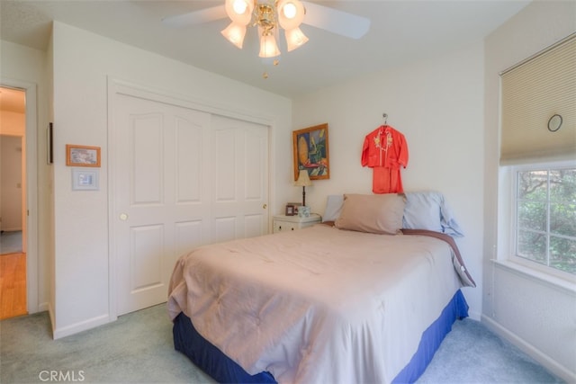 carpeted bedroom with a closet and ceiling fan