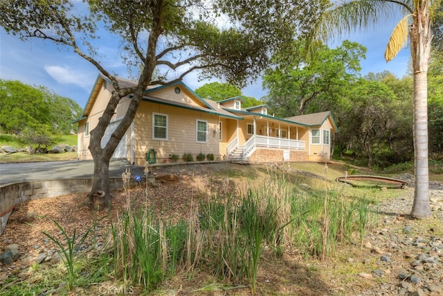 rear view of property featuring a porch