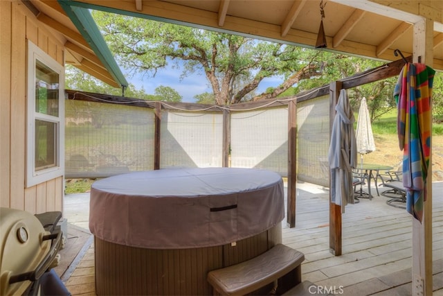 wooden terrace featuring a hot tub