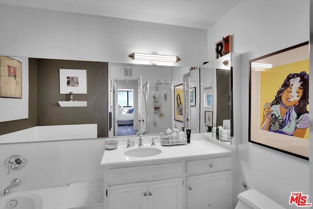 full bathroom featuring vanity, toilet, and shower with separate bathtub