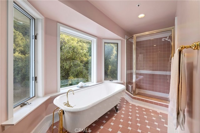 bathroom with independent shower and bath and plenty of natural light