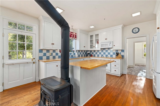 kitchen with white cabinetry, white appliances, light wood-type flooring, and butcher block countertops