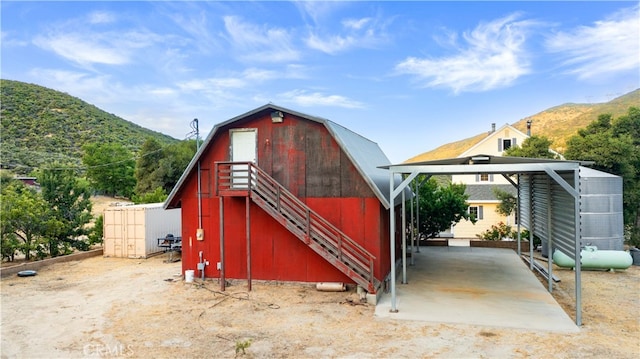 view of outbuilding featuring a mountain view