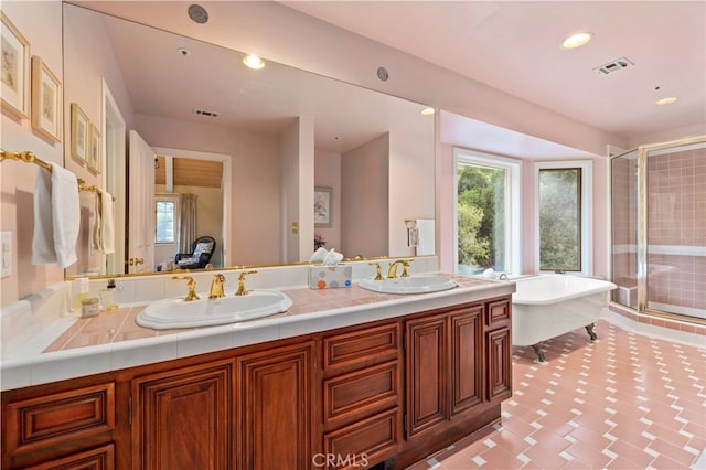 bathroom featuring vanity and separate shower and tub