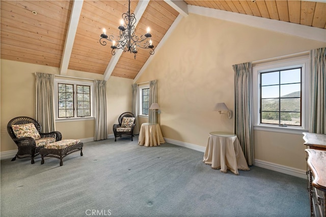 living area featuring beamed ceiling, carpet, and a wealth of natural light