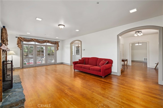 living room with french doors and hardwood / wood-style floors