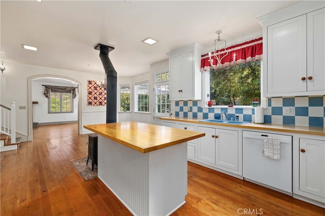 kitchen featuring white cabinetry, backsplash, light hardwood / wood-style flooring, and wooden counters