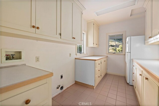 kitchen featuring white fridge and light tile patterned flooring