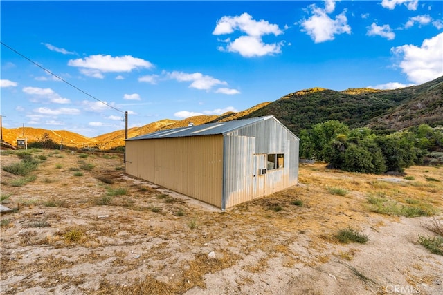 view of outbuilding featuring a mountain view