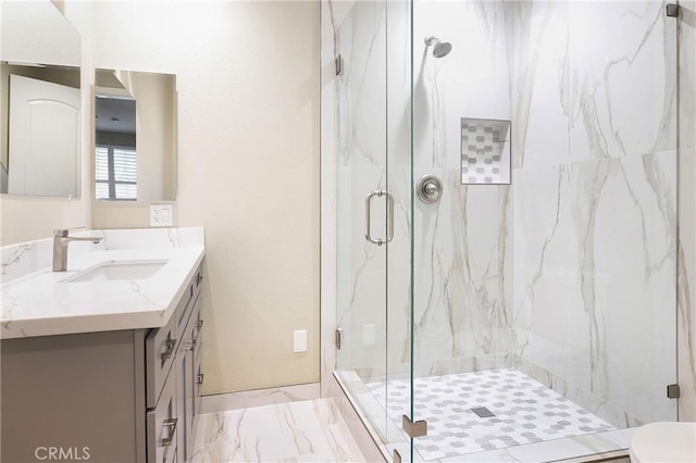 bathroom featuring an enclosed shower and vanity