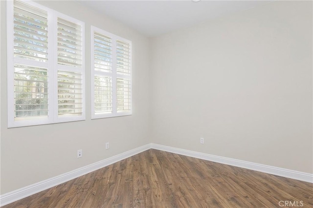 spare room with hardwood / wood-style floors