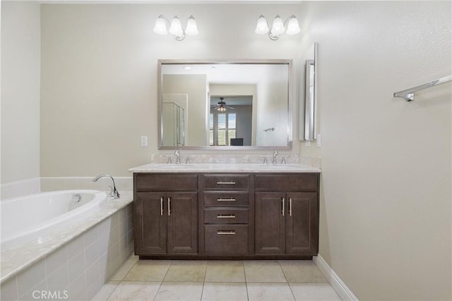 bathroom featuring double vanity, tile patterned flooring, a sink, and a bath