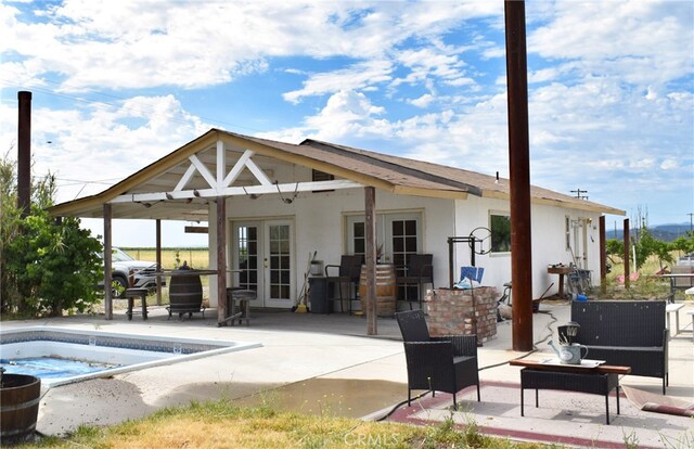 back of property with french doors and a patio area