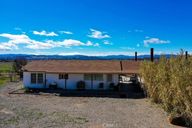 view of front of house with an attached carport and a mountain view