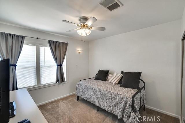 bedroom with visible vents, carpet floors, baseboards, and ceiling fan