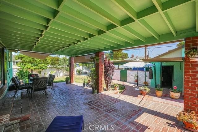 view of patio / terrace featuring outdoor dining area and fence