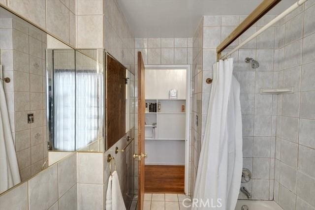 full bathroom with shower / bath combination with curtain and tile patterned floors