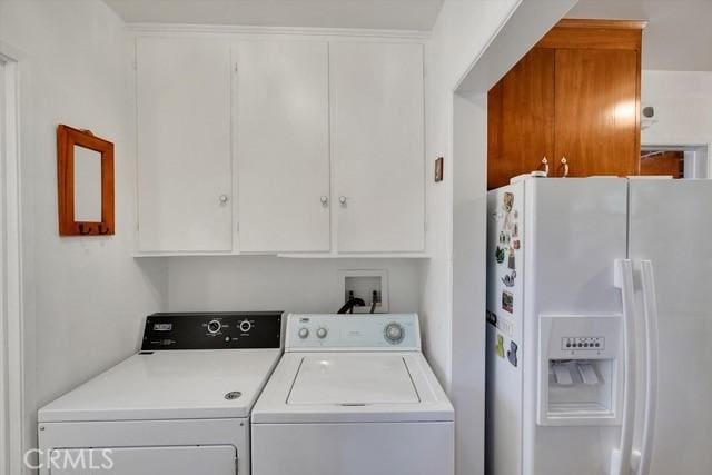 washroom featuring cabinet space and independent washer and dryer