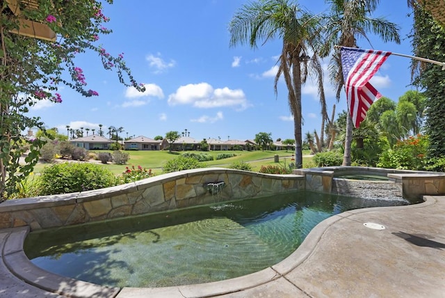 view of pool featuring an in ground hot tub