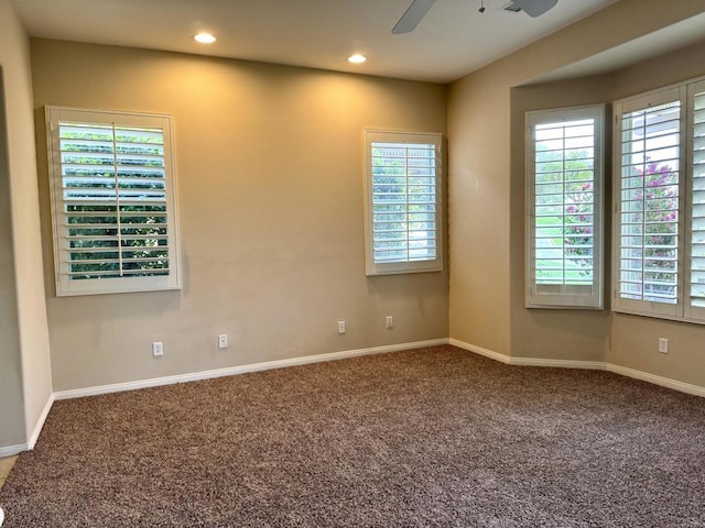 carpeted spare room with ceiling fan