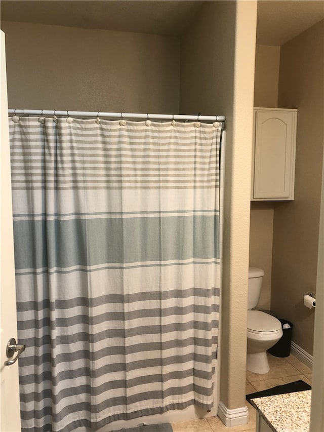 bathroom featuring vanity, toilet, and tile patterned floors