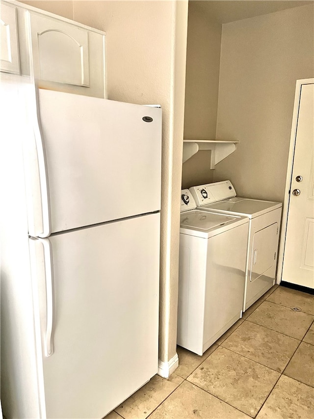 laundry area featuring light tile patterned flooring and washer and dryer