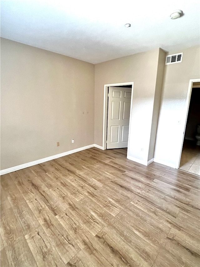 empty room with light hardwood / wood-style floors