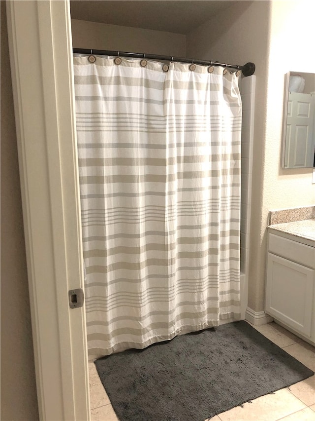 bathroom featuring vanity, a shower with curtain, and tile patterned floors