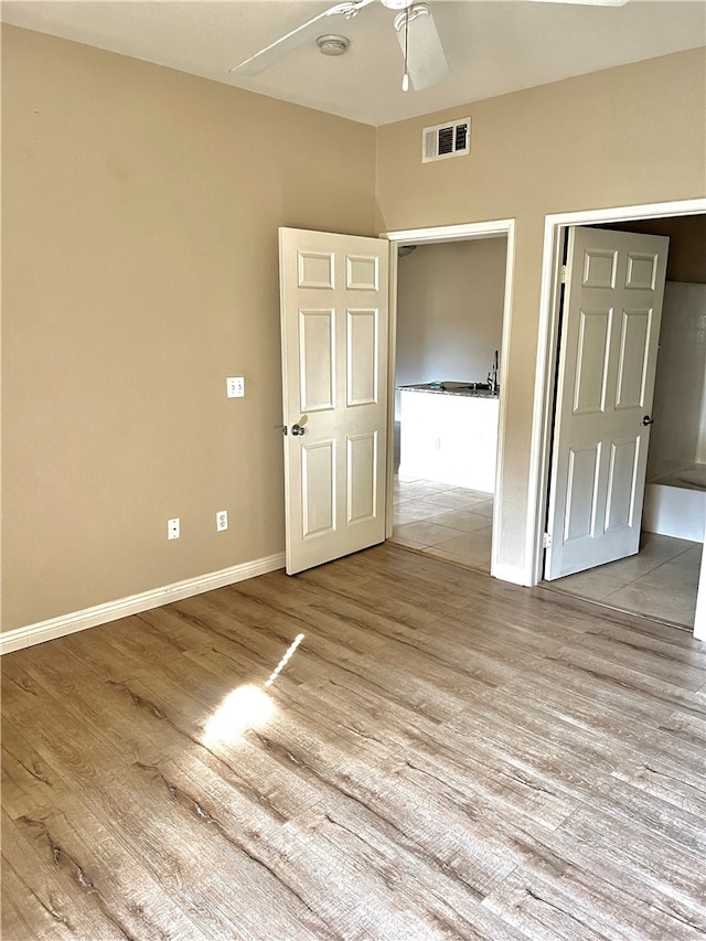 interior space with light hardwood / wood-style floors and ceiling fan