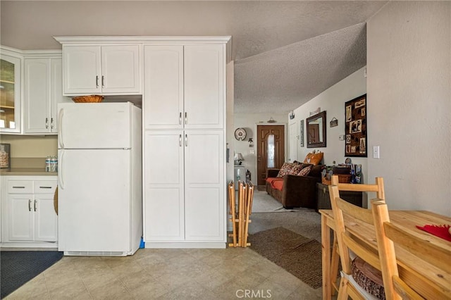 kitchen with white cabinetry and white refrigerator