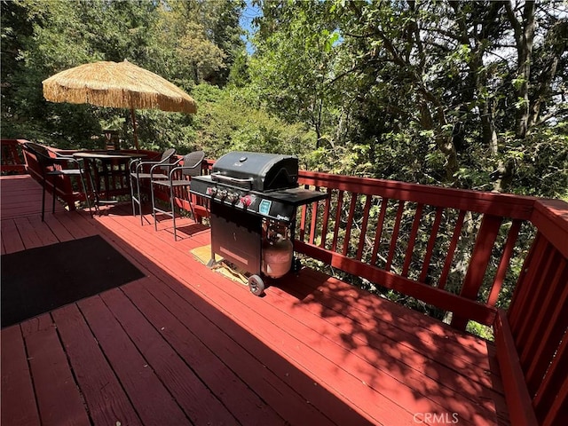 wooden terrace with area for grilling