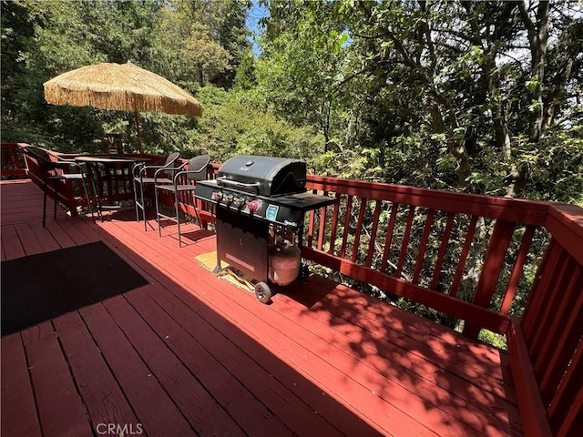 wooden terrace with area for grilling