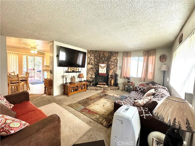 living room with ceiling fan, light carpet, and a textured ceiling