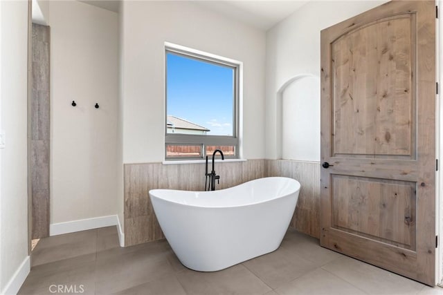 bathroom featuring tile patterned flooring and a bathtub