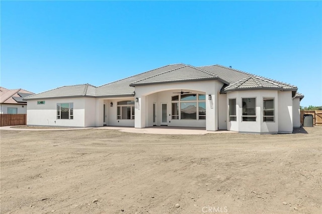 rear view of property with ceiling fan