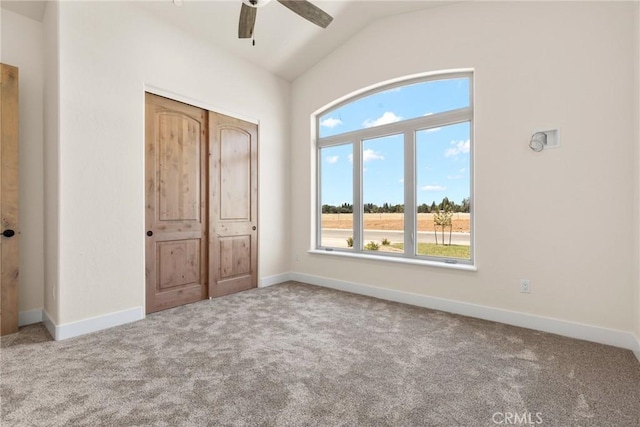 unfurnished bedroom featuring ceiling fan, light colored carpet, and a closet