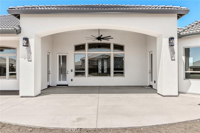 property entrance featuring ceiling fan and a patio