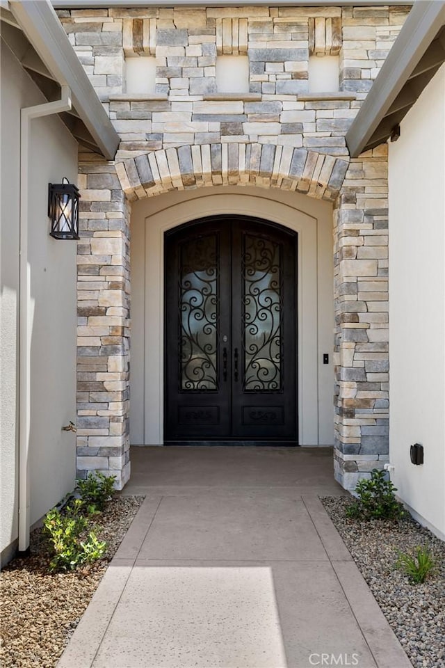 view of exterior entry featuring french doors