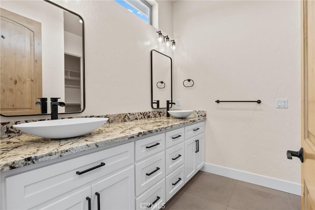 bathroom featuring tile patterned flooring and vanity