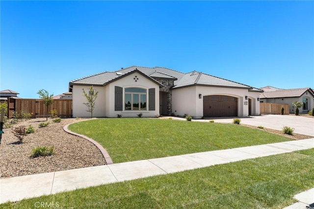 view of front of house with a front yard and a garage