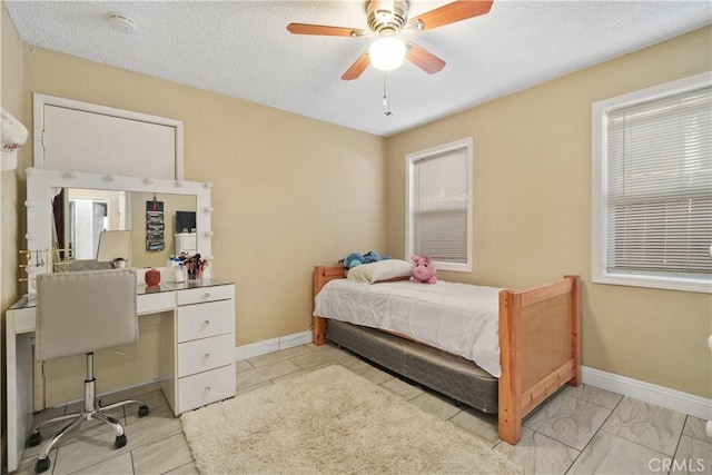 bedroom with a textured ceiling and ceiling fan