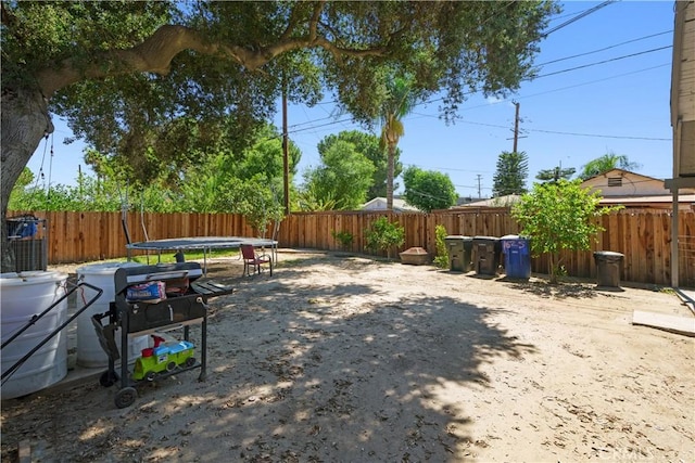 view of yard featuring a trampoline and a patio area